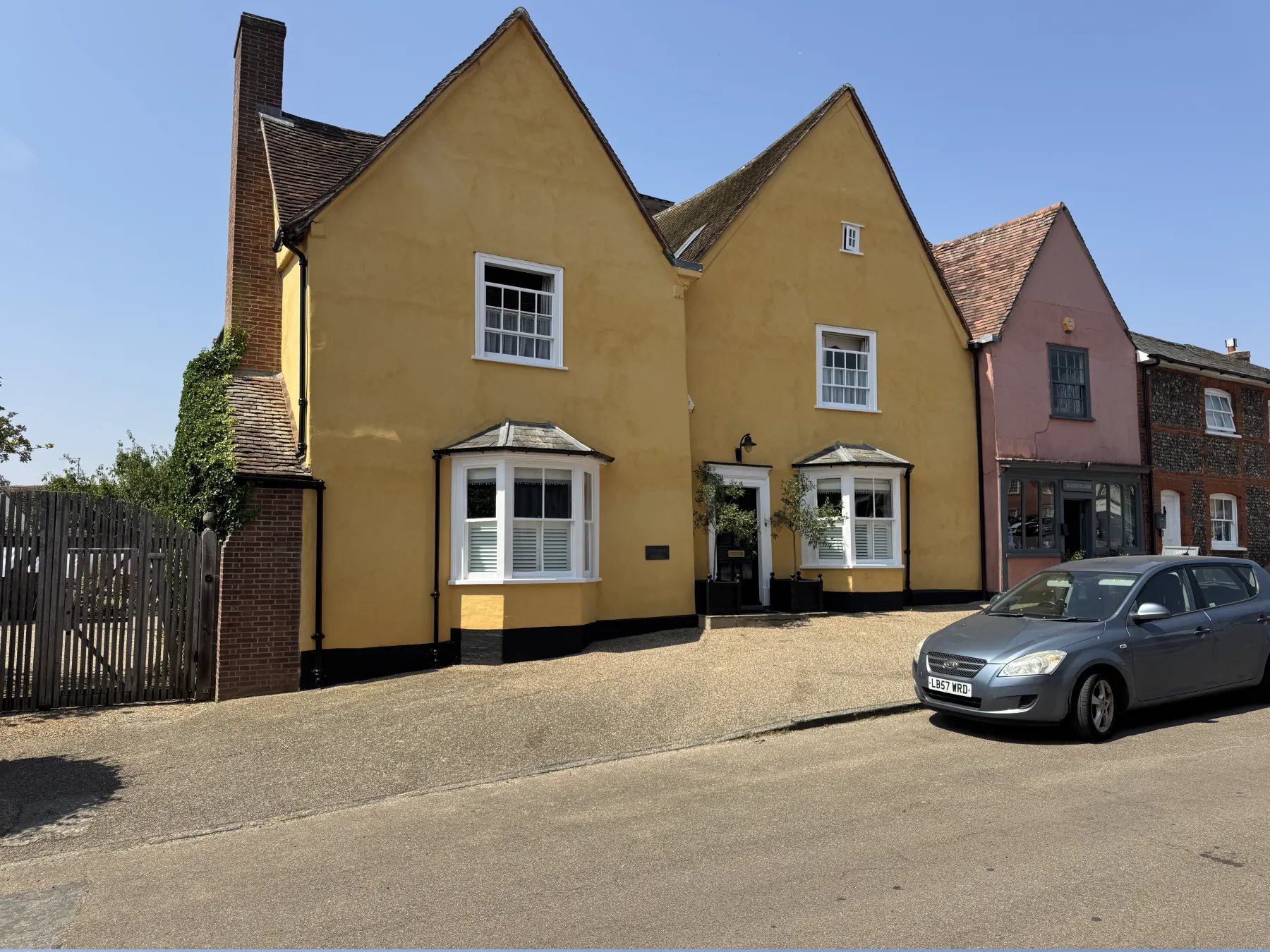 Angled view of Lavenham period exterior showing render, roofline and bay windows