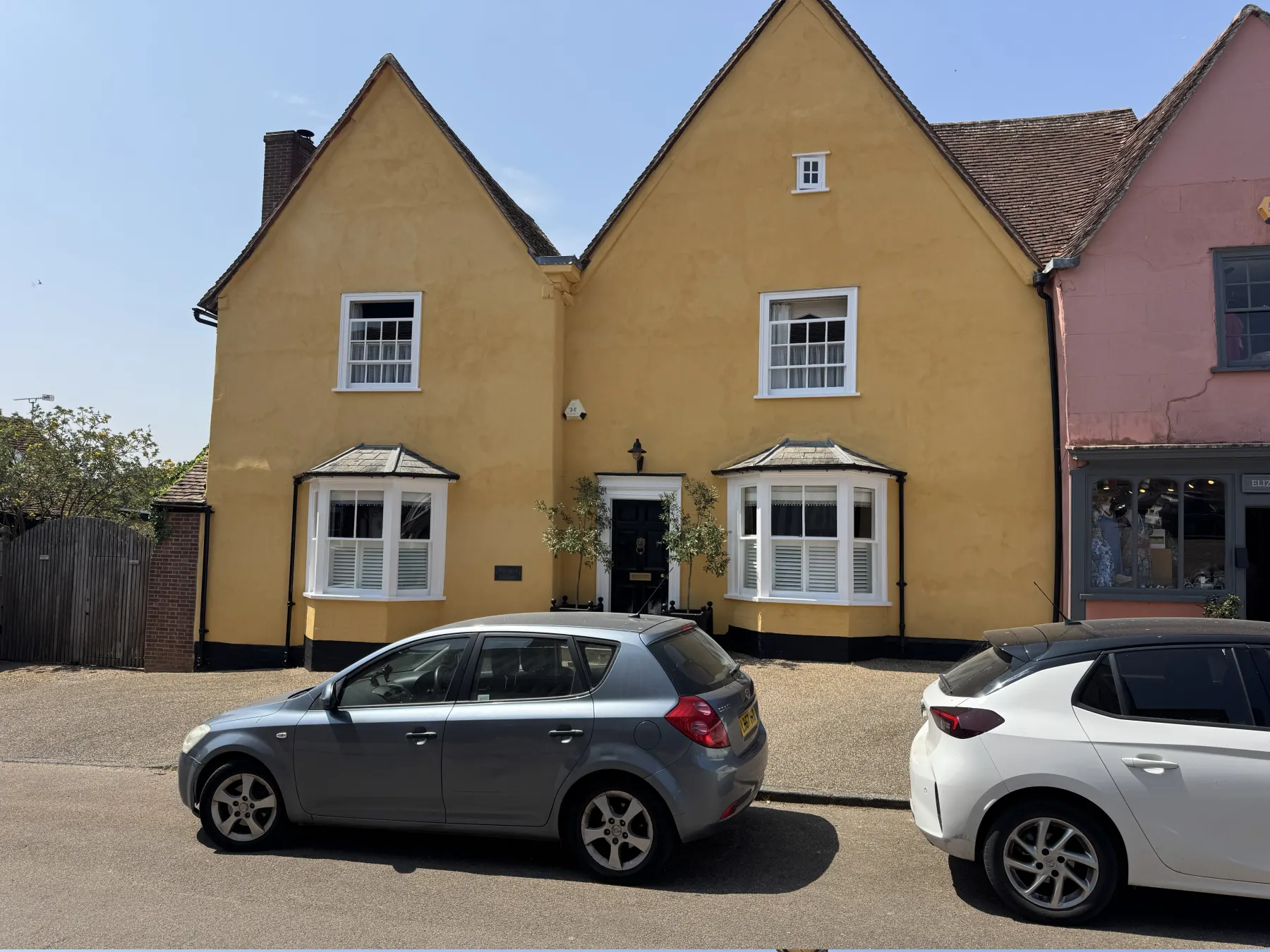 Front view of Lavenham period exterior with yellow render and white trim