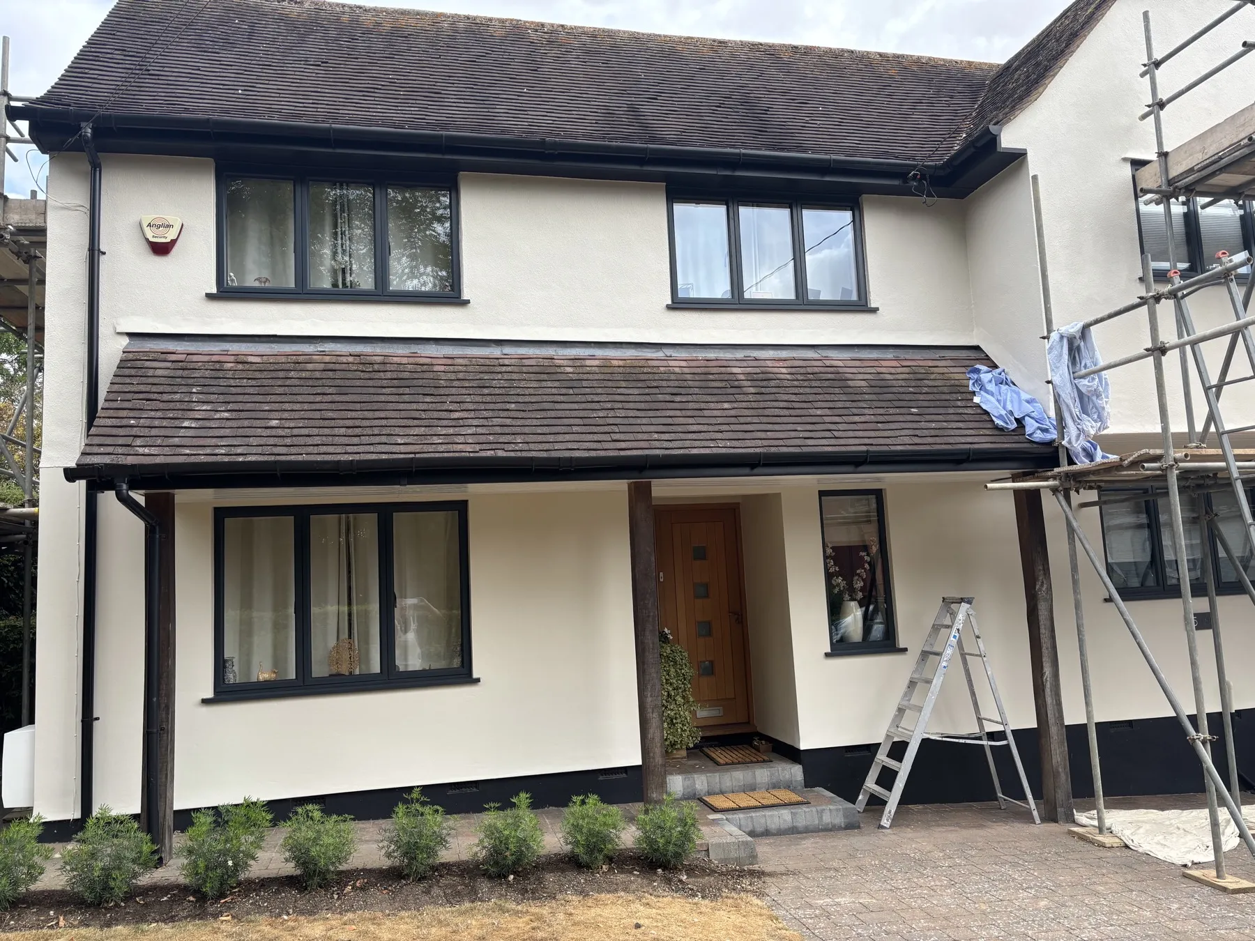 Front elevation of the Lavenham house during the render job, scaffolding still up on one side