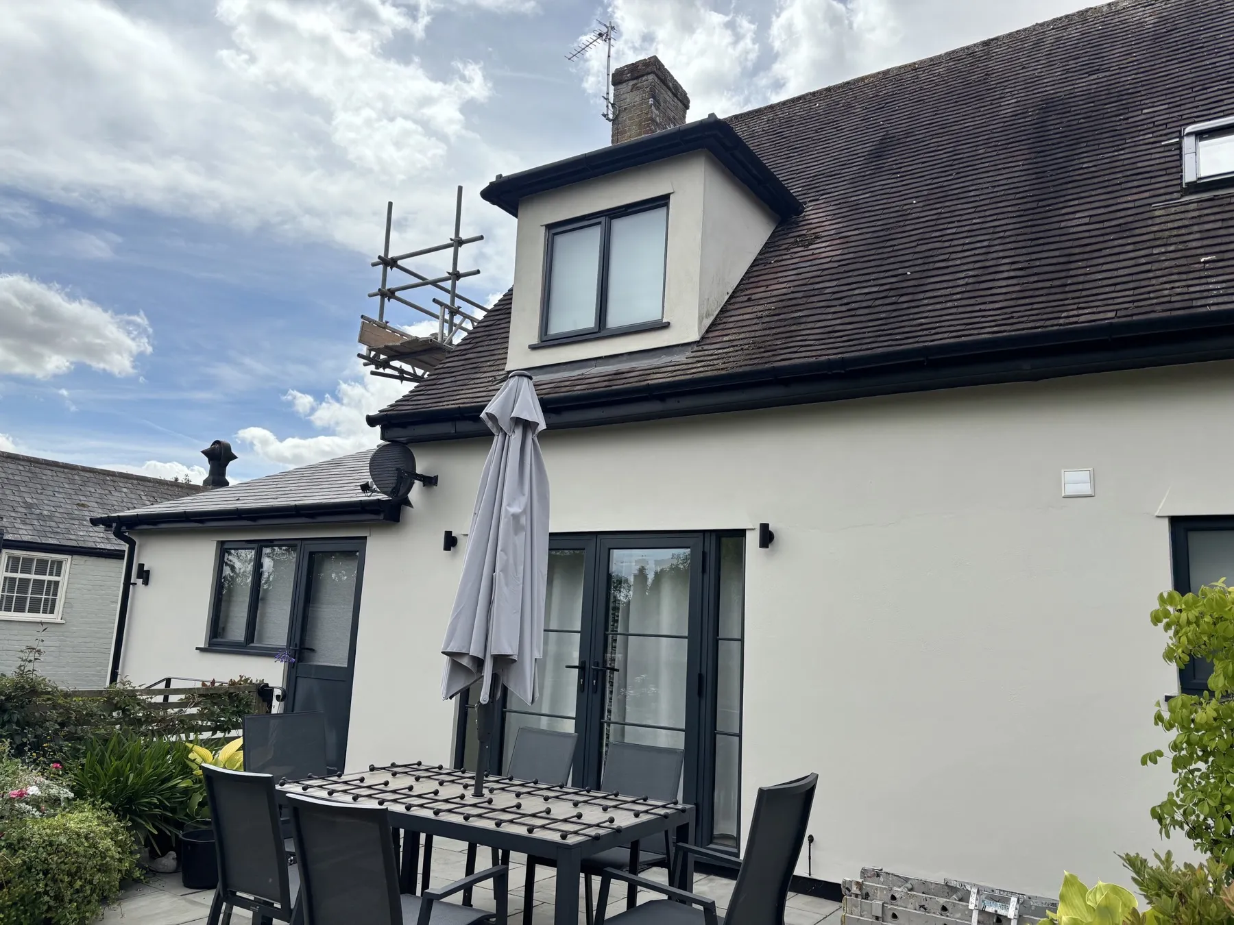 Wider rear view of the render job with garden and dormer window