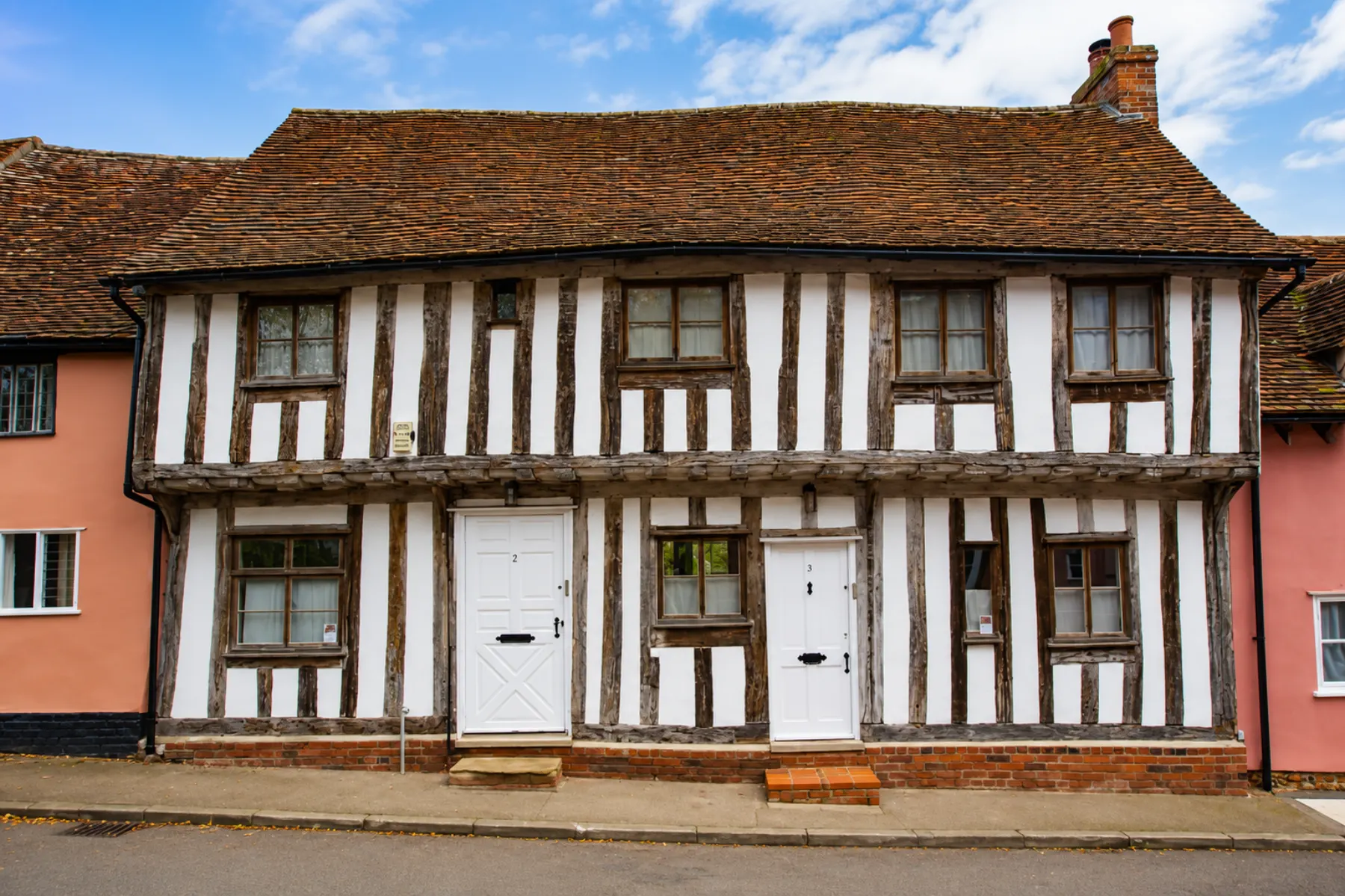 Timber-framed cottages in Lavenham with white painted doors and exterior panels