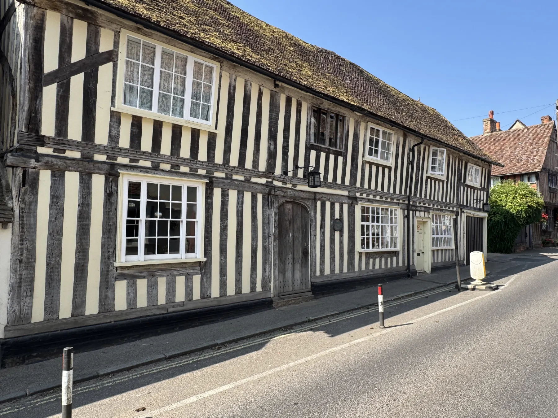 Timber-framed period exterior with white painted windows and traditional black timber beams